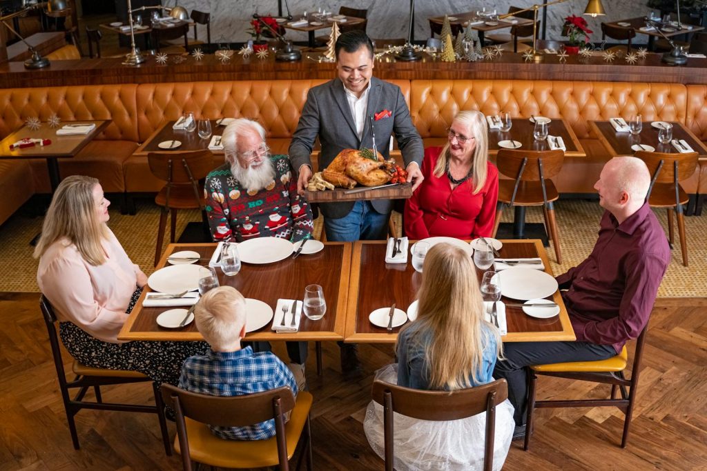 A family laughing together while enjoying a meal at one of the best family-friendly restaurants in Washington DC