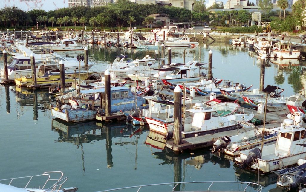 A vibrant view of Tamsui Fisherman's Wharf with numerous boats moored in Taipei, Taiwan.