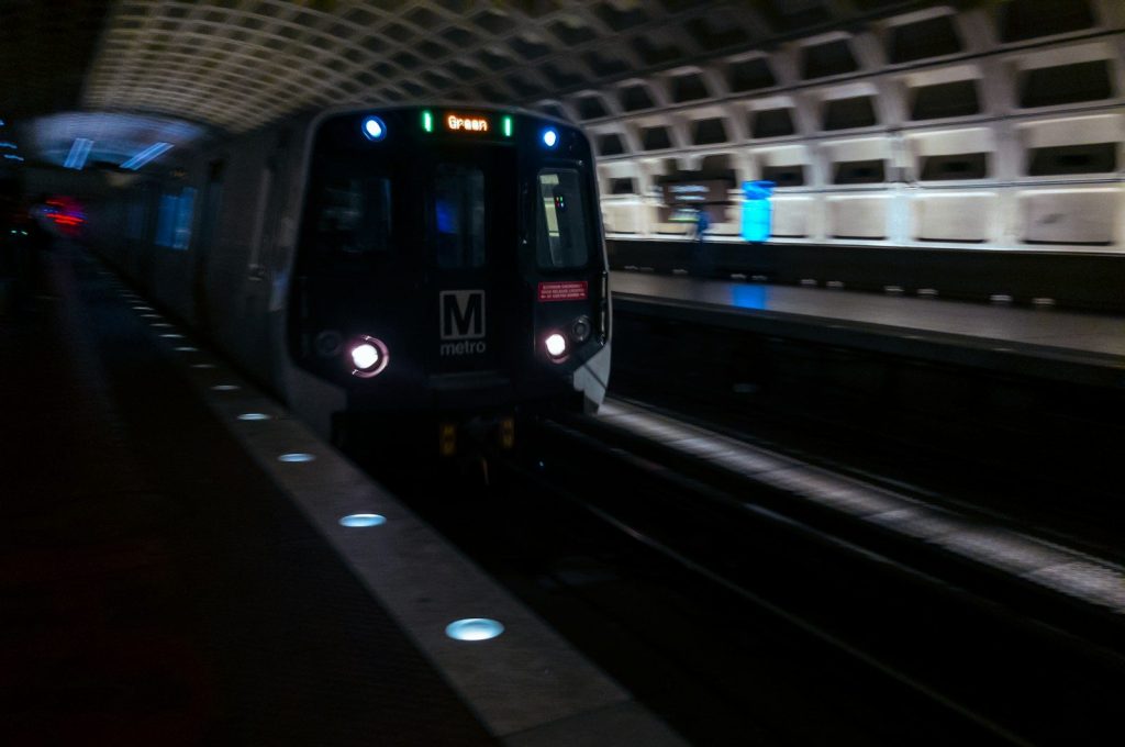 a train traveling through a train station at night