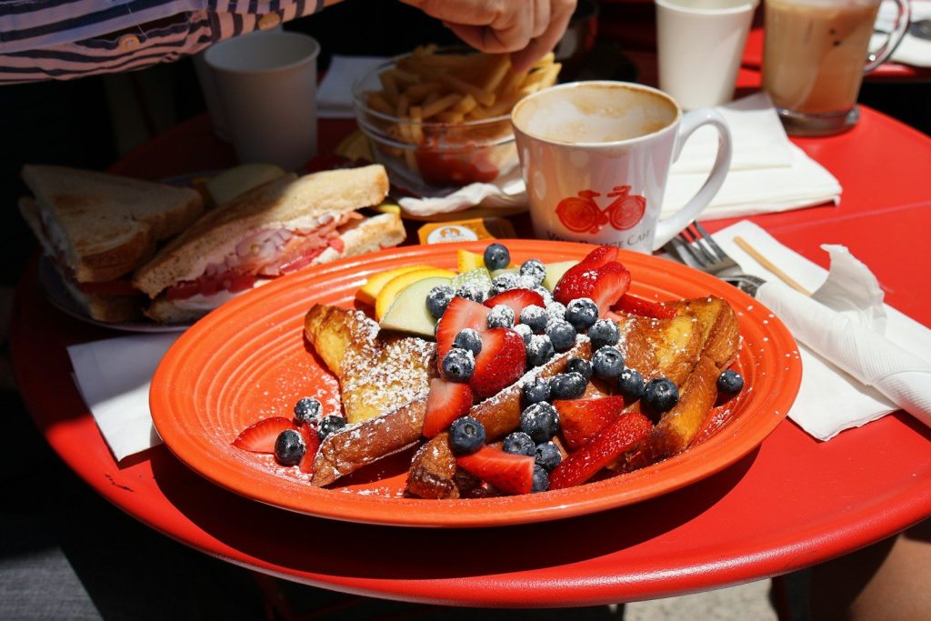 French toast with strawberries and blueberries on plate