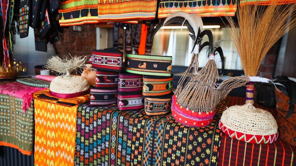 Colorful hats and woven items are on display.