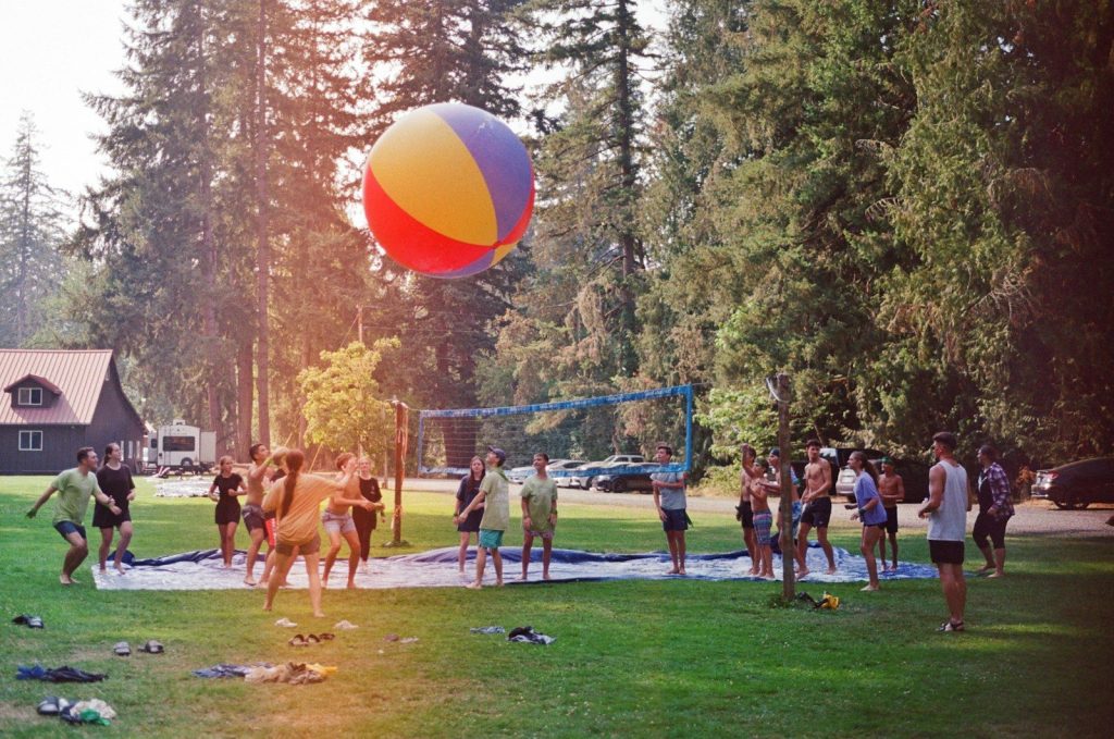 a group of people standing around a beach ball