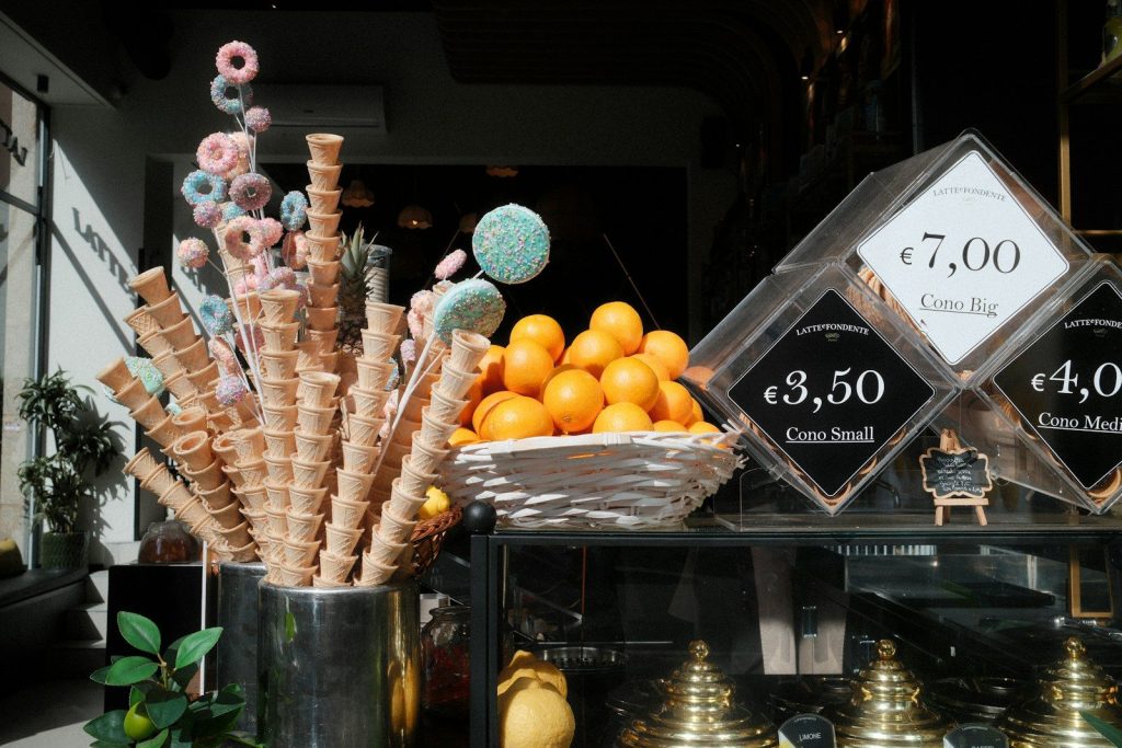 Ice cream cones and oranges displayed at a shop