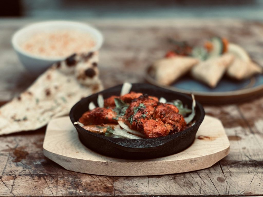 Indian food with naan, samosas, and rice