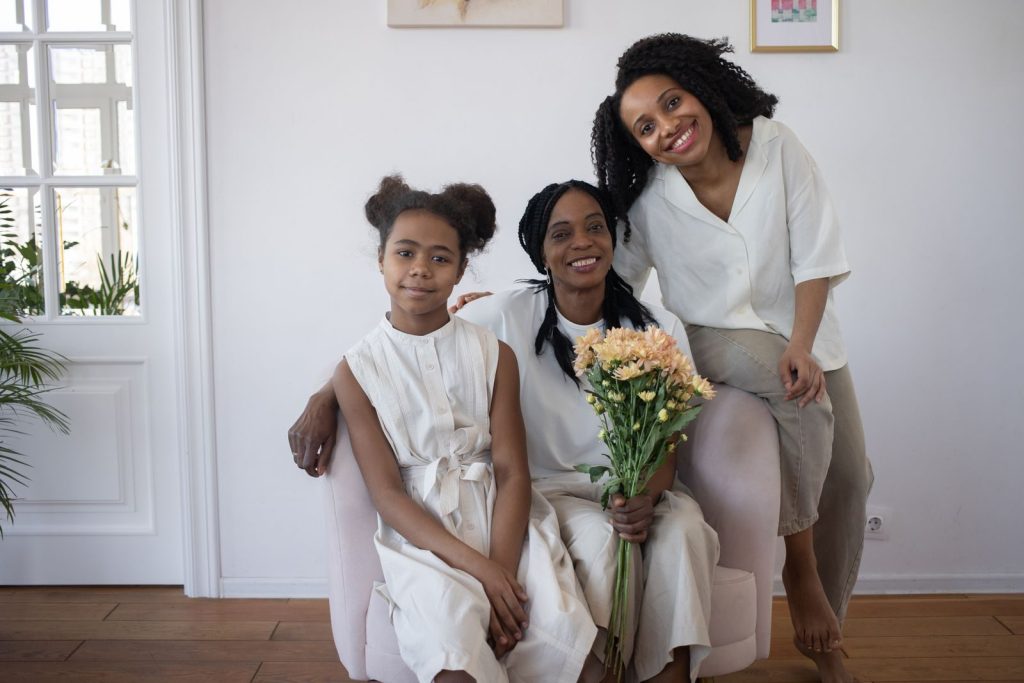 Three generations of Mothers smiling together, showing family bonds and happiness.