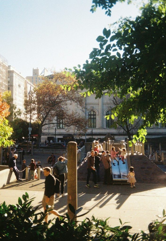 People enjoying a sunny day at a playground