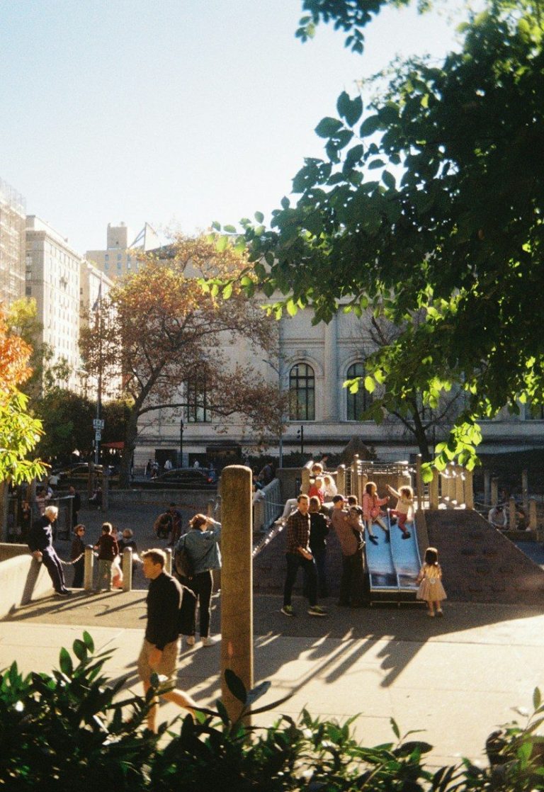 People enjoying a sunny day at a playground